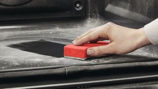 hand cleaning ash out of pyrolytic oven